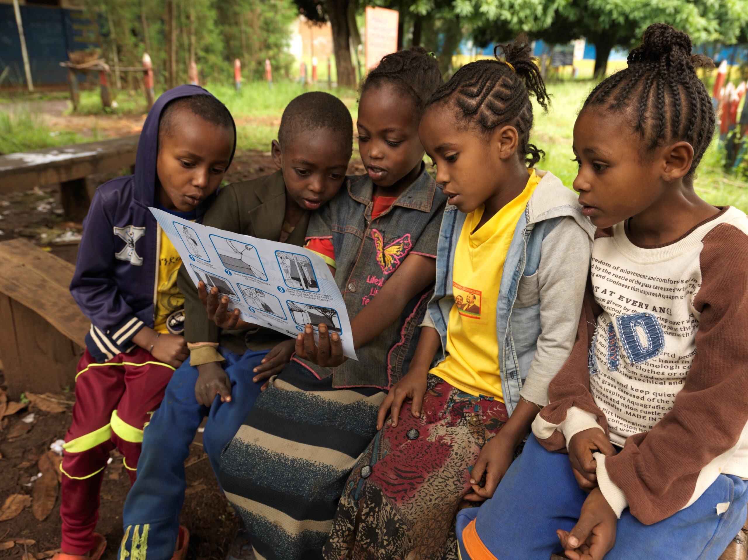 Children At Himbecho Primary School In Boloso Sore, Ethiopia, Read Illustrations On Malaria Prevention © Malaria Consortium