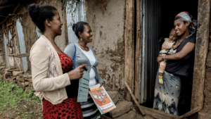 Workers from Ethiopia’s Health Extension program talk with a mother at her home.
