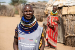 Health worker from Amref Health Africa’s SIWA programme standing in a community setting in Kenya.